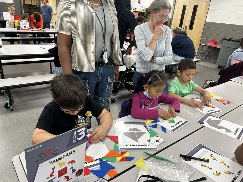 Families enjoying tanagrams at Family Fun Night