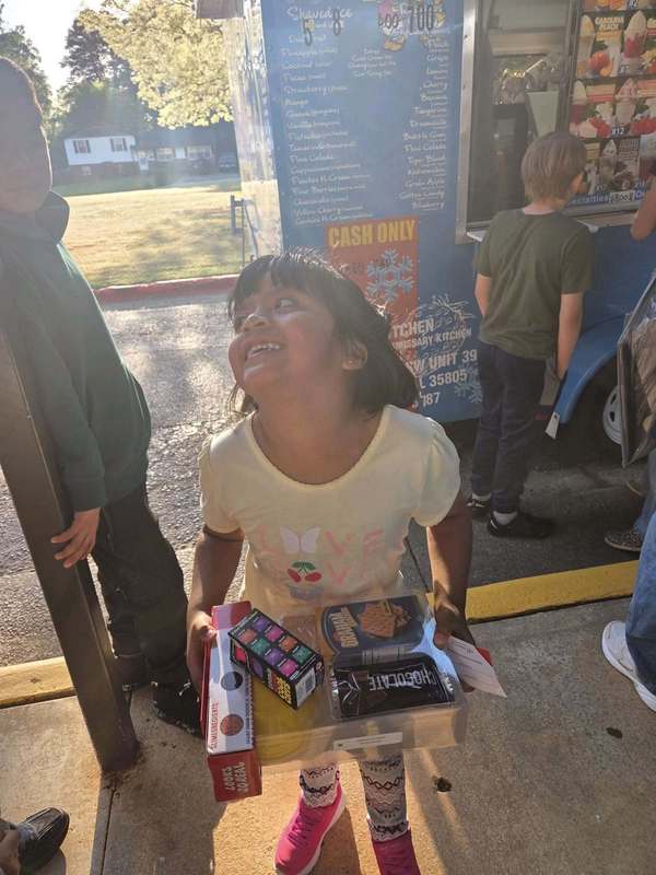 A preschooler excited that she won a prize from Mathnasium!