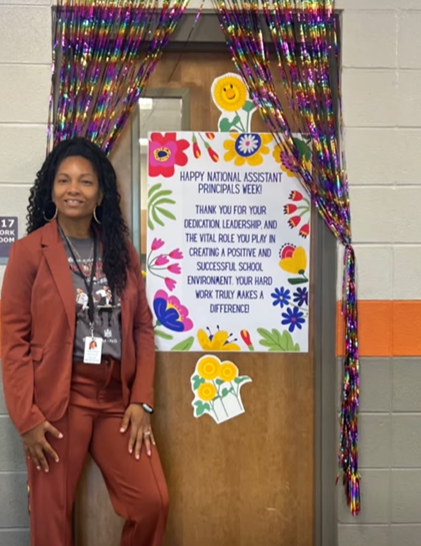 Mrs. Lattimore poses beside her decorated door. 
