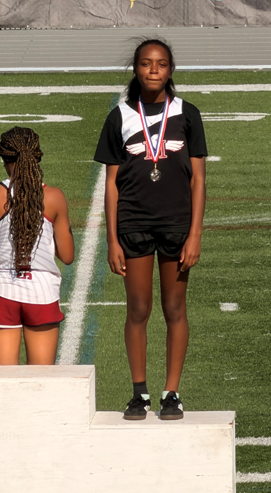 A Rowe stands on a podium