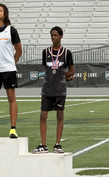 An J Pickens stands on a podium