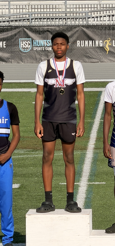 K Robinson stands on a podium in first place