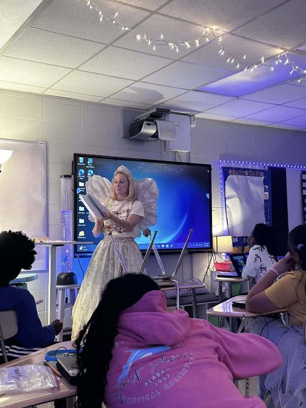 Third grade students listening to the Book Fairy read to them.