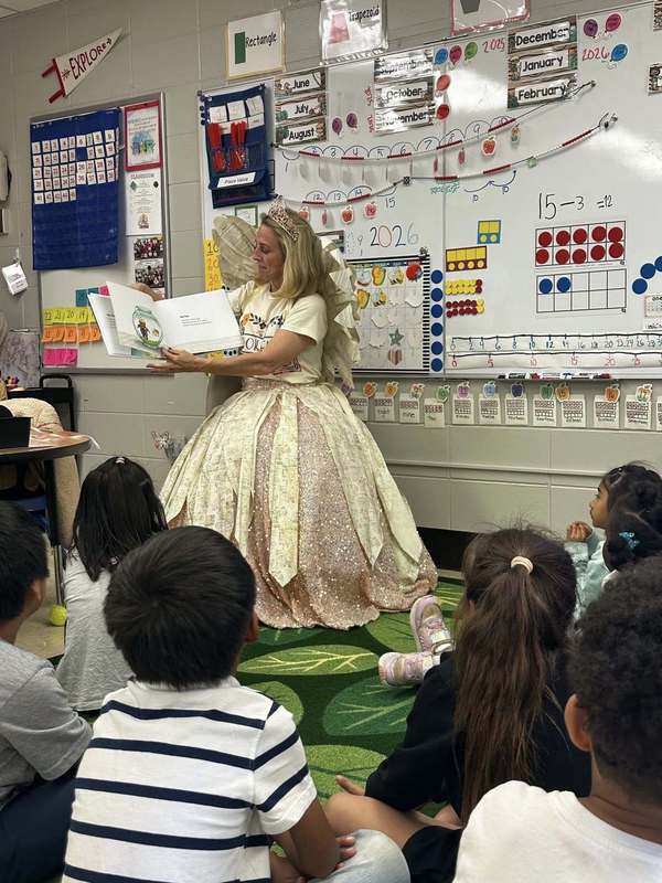 The Book Fairy reading a funny book to a Kindergarten class.