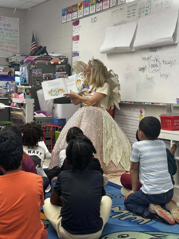 The Book Fairy reading to a class of first graders.