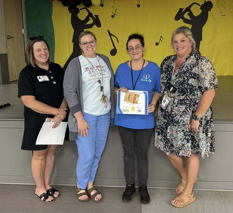 Admin and a cimmunity member presenting Ms. Christina with her certificate and gift card.