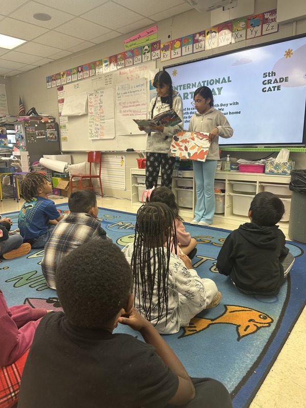 Two GATE students reading to first graders
