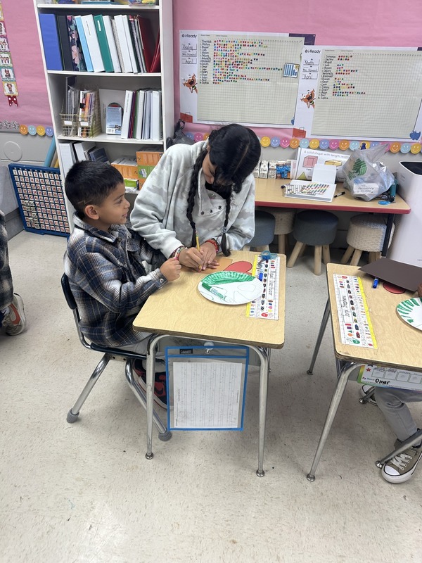 One of our fifth grade GATE students assisting with a craft.