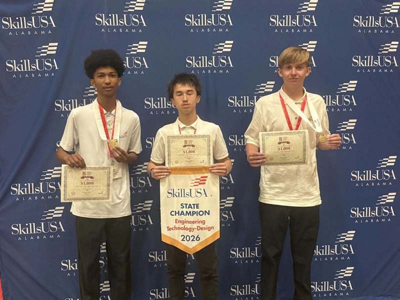 Three students hold their SkillsUSA State Champion Engineering Technology-Design 2026 winner banner. These students won 1st place and also are holding their $1,000 scholarship certificates.