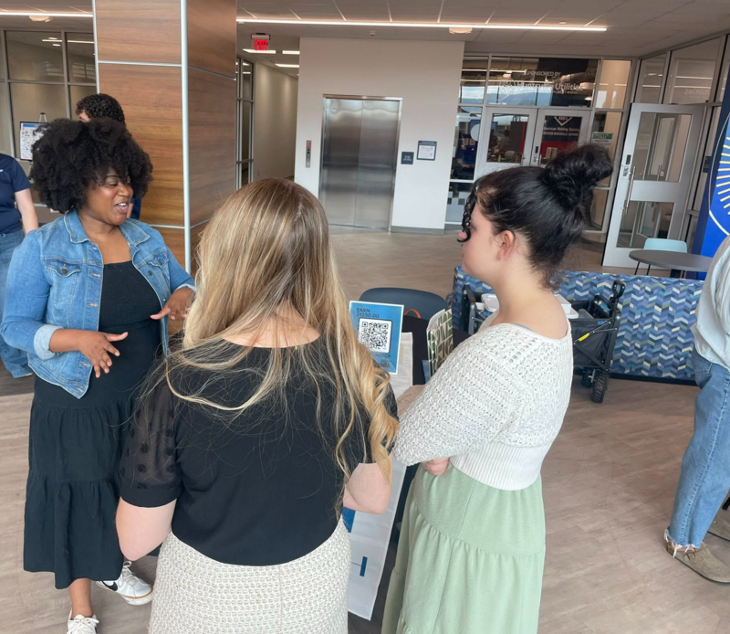Students at the Center for Technology speak with a person from HATCH.