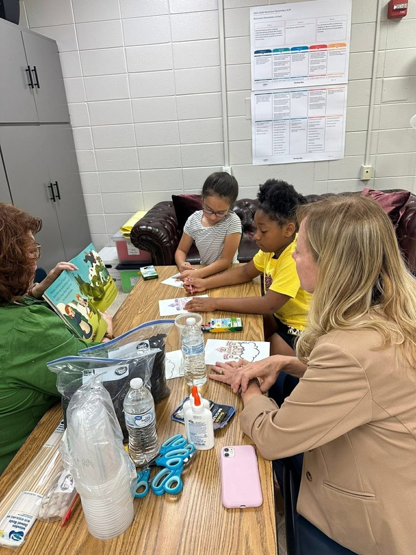 Students making a craft with Mrs. Hicks and Ms. Hatcher during their Science of Fairy Tales Club.