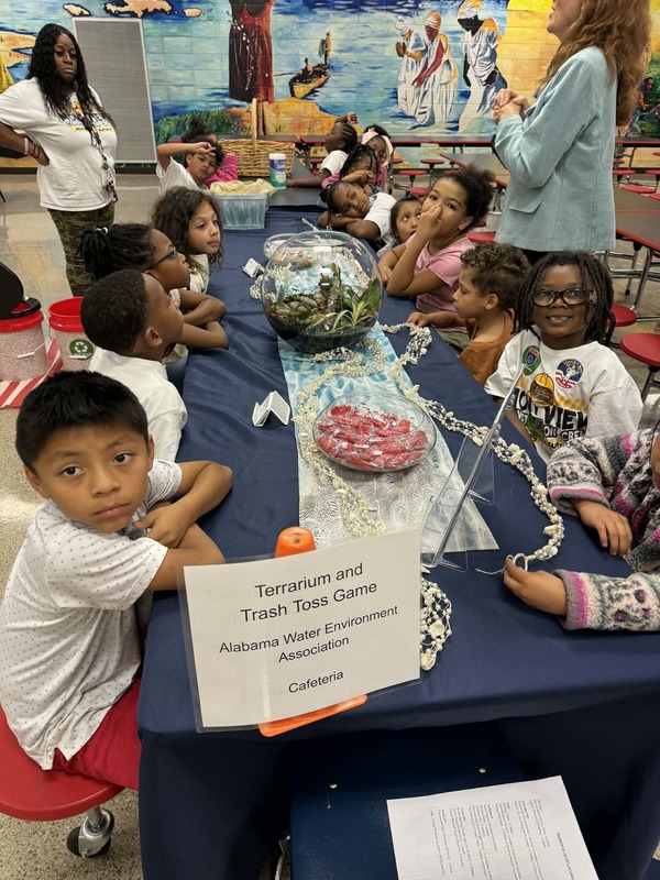 2nd grade students learning about the environment at the Alabama Water Environment Association station.