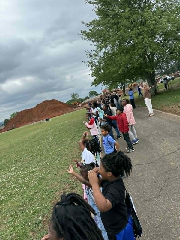 The entire school is outside on the track waiting for the rocket to launch.