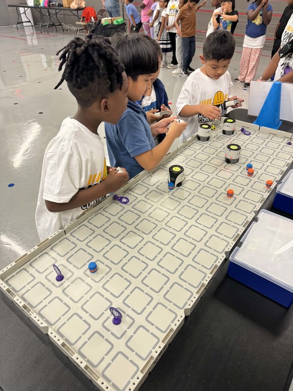 Kindergarten students using the bots at the Botley 2.0 & VEX Aim Robotics station.