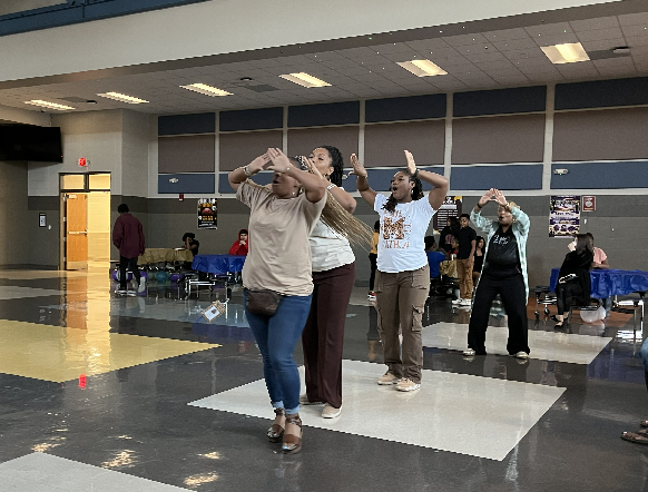 Mrs. Jones, Mrs. Lattimore, Mrs. Elike and Dr. Burruss performing a  stroll for the students. 