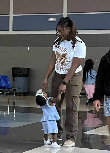 Mrs. Elike dacing with her 16 month old daughter