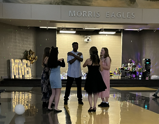 A group of 5 students doing the Macarena