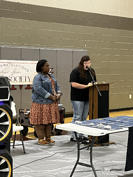 Jolene Lewis delivers a message to the assembly during the 2025-26 National Junior Honor Society induction ceremony