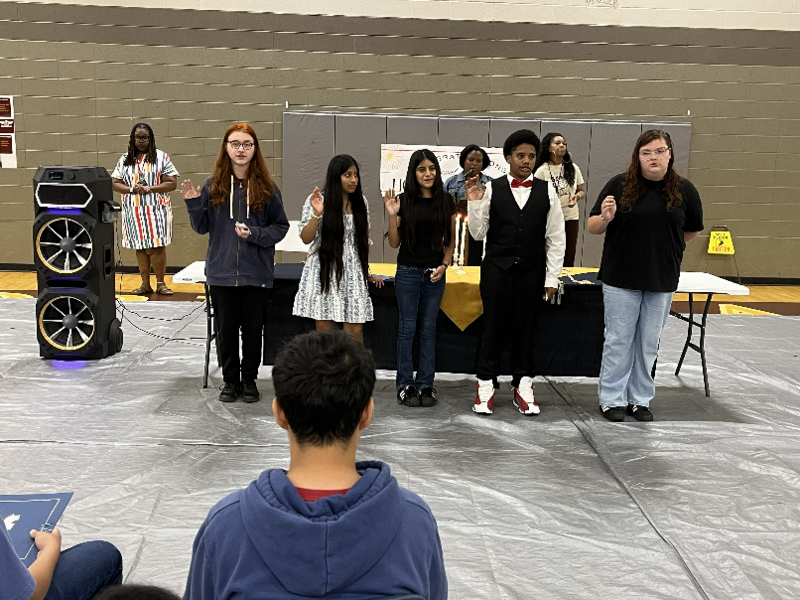 Next year's leadership committee for the NJHS raise their right hands and make their pledges as officers