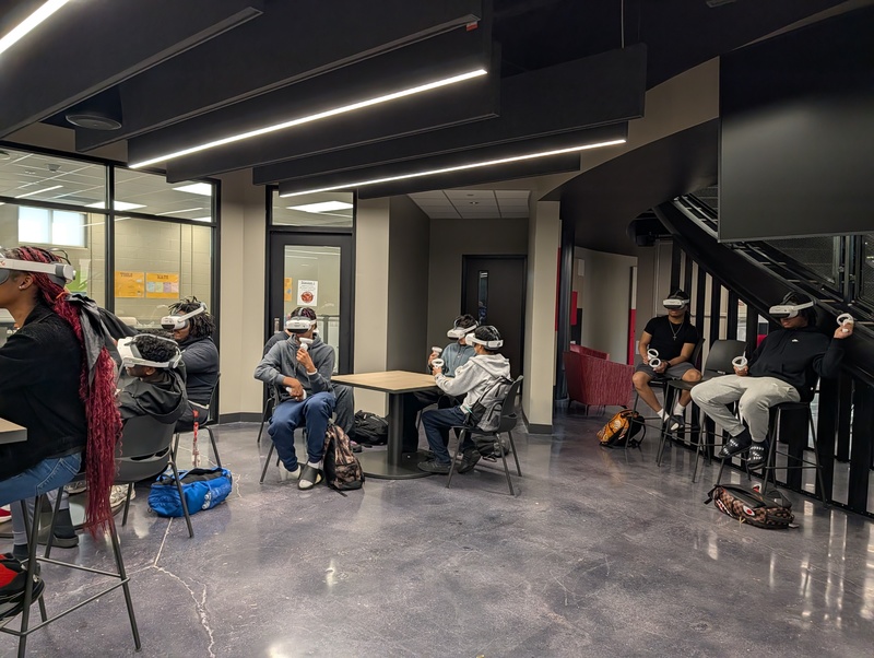 Students in chemistry class sitting at tables using Virtual Reality Headsets in the Innovation Center