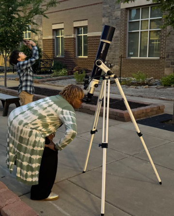 Dr. Burruss taking a turn at the telescope at the Spring Dance