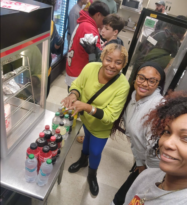 Dr. Burruss manning the concession stand with faculty and students