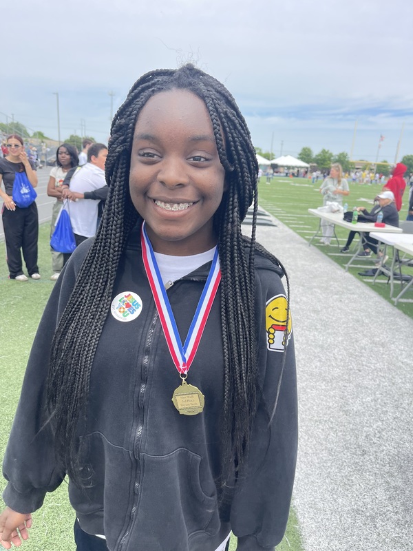 Aaliyah with her medal after her 50 m run.