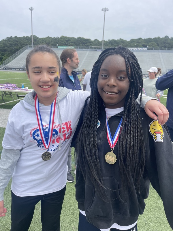 Lela and Aaliyah with their medals after wining third place in the 50 m run