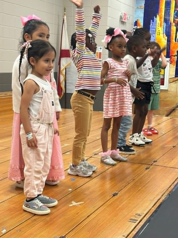 Pre-K students on the stage performing "Funga Alafia."