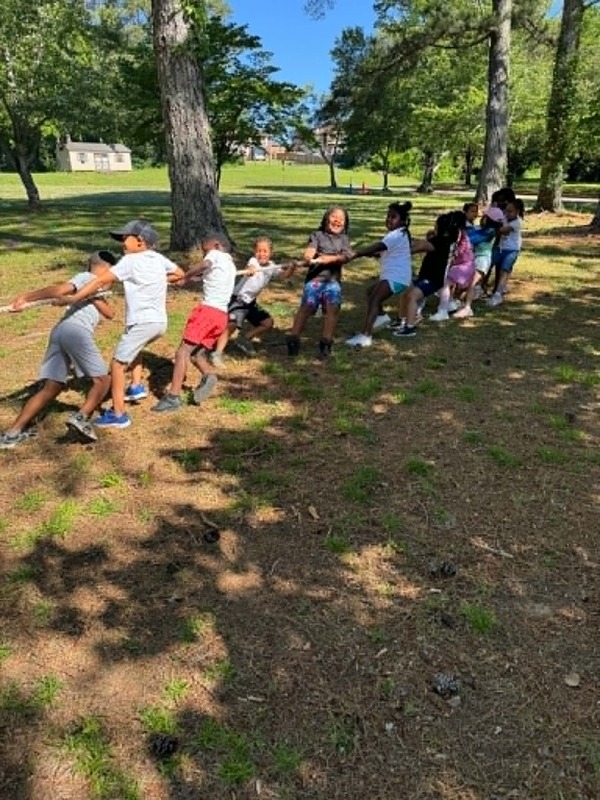 First grade students competing at tug of war.