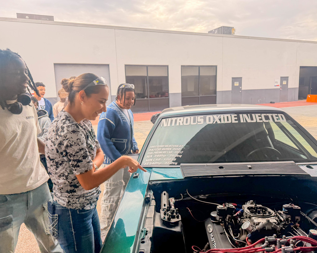 Students look at the front of a high performance vehicle