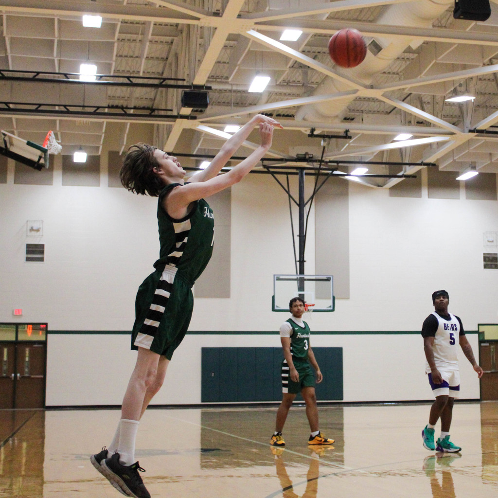Boy stretches out for jump shot