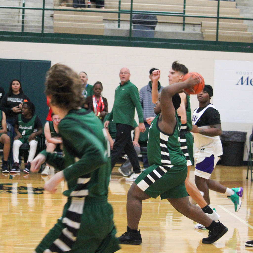 boy winds up for a big throw- attempt at basket