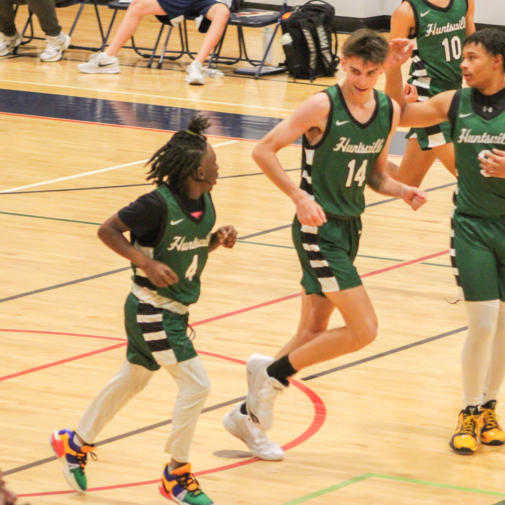 Team mates smiling at each other on the court