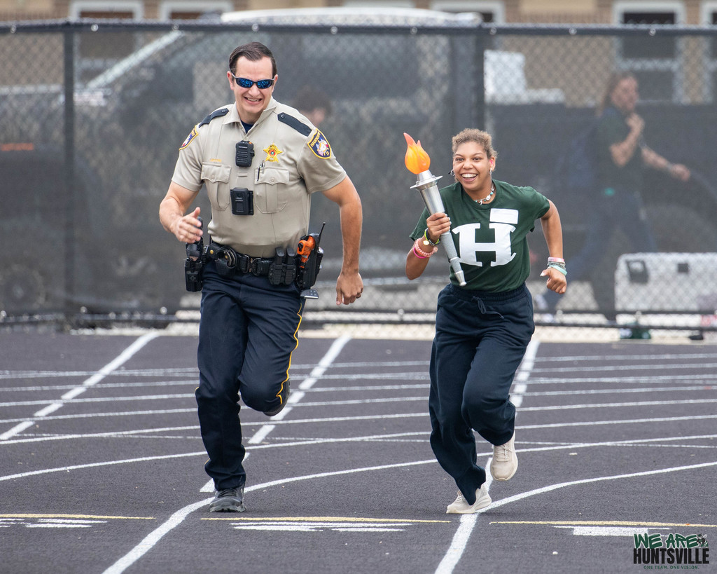 Police officer and student torch runner