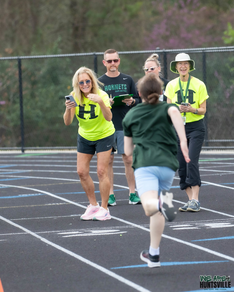 Adults cheering on atlhete