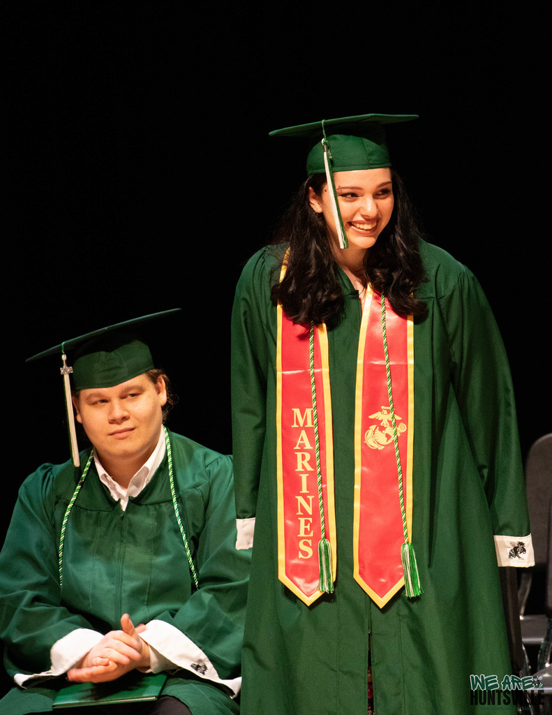 Proud graduate with Marine banner