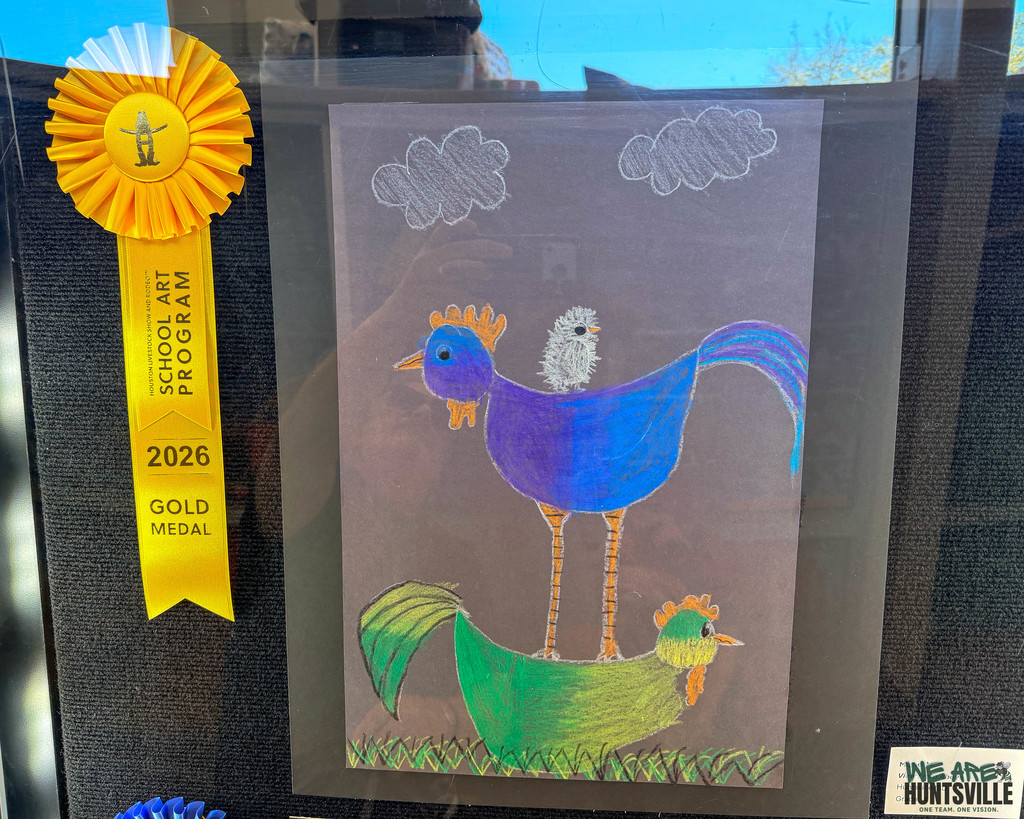 a chicken, on top of a chicken, on top of a rooster art piece