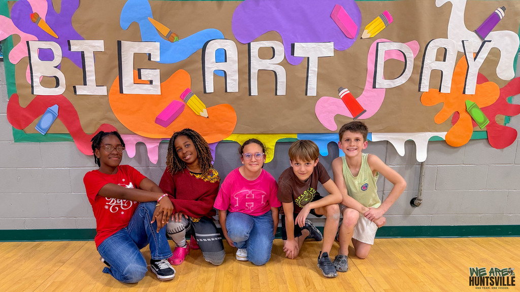 students in front of mural