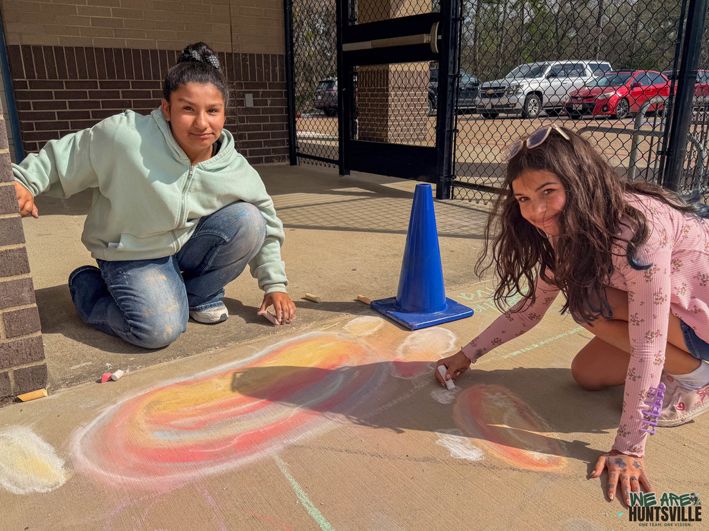 Two girls taking a break from chalk
