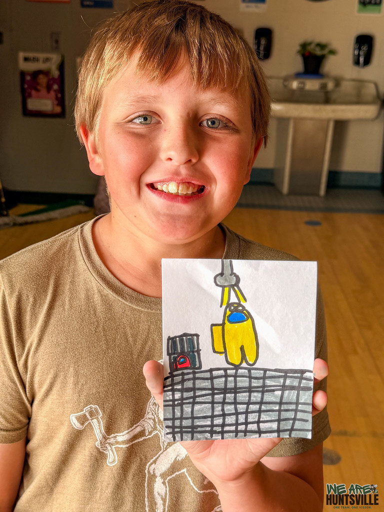 Kid showing his drawing