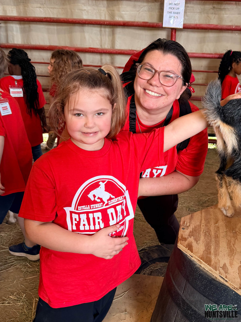 a teacher and a student pose for a photo