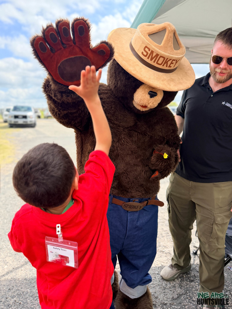 high fiving smokey the bear