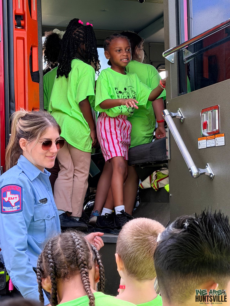 firefighter supervises kids
