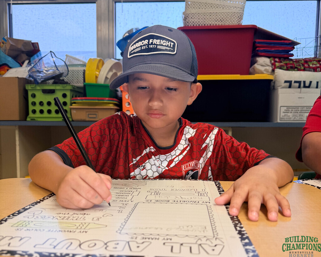 Kid with big hat working on a form