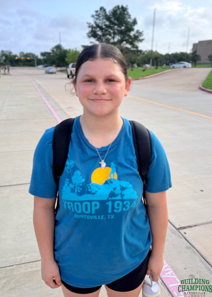 younger student poses outside after practice