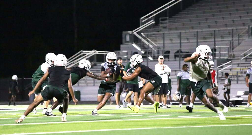 running back navigates through two defenders with ball