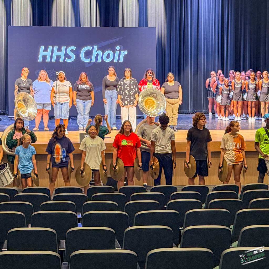 The band, the cheer team and the choir all together on stage