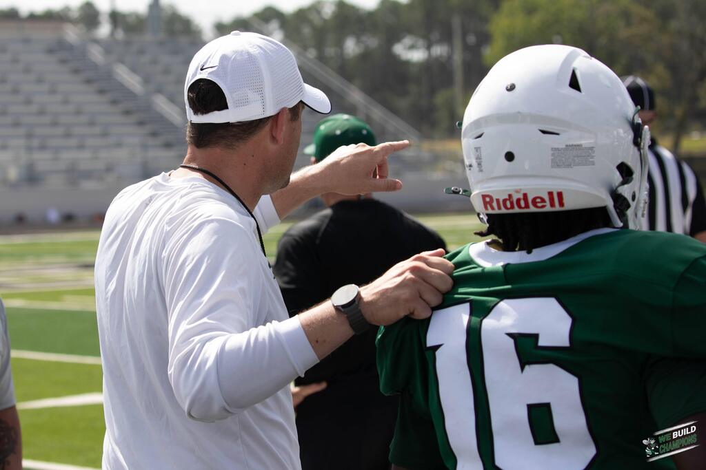 coach with hand on shoulder