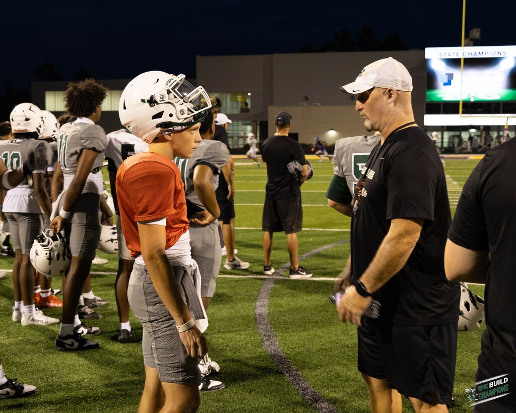 Coach and player having serious conversation